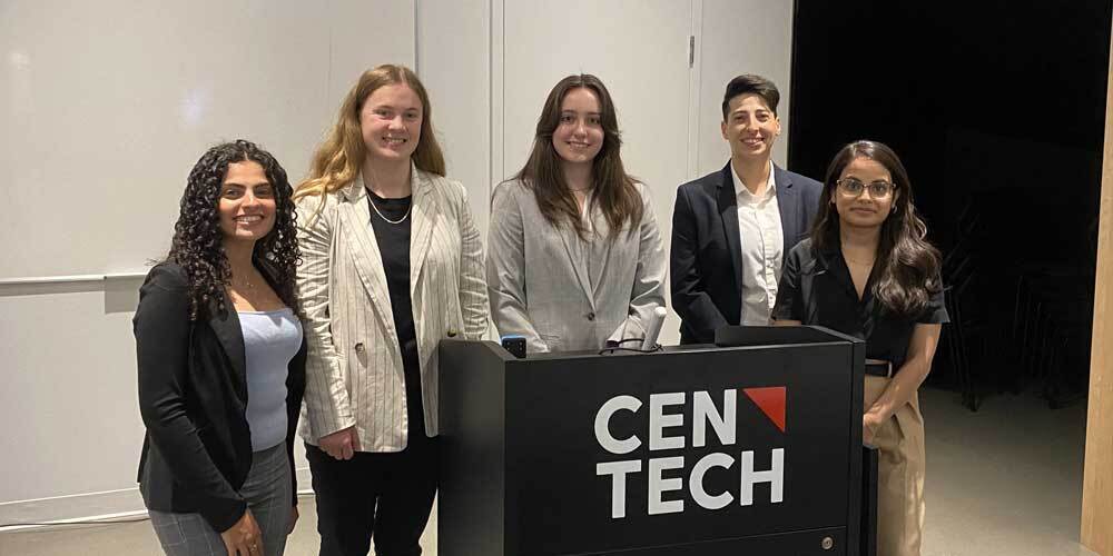 2023 Cross-Company Collaborative Event at CAE, Montreal, QC left to right: Magy Gerges, Electrical Engineering Co-Op (Thales); Emma Piers, Software Engineering Co-Op (CAE); Mégane Riopelle, Systems Engineering Co-Op (Thales); Merriem Iddir, Cybersecurity Co-Op (L3Harris); Vaishnavi Kotha, Software Engineering Co-Op (L3Harris)