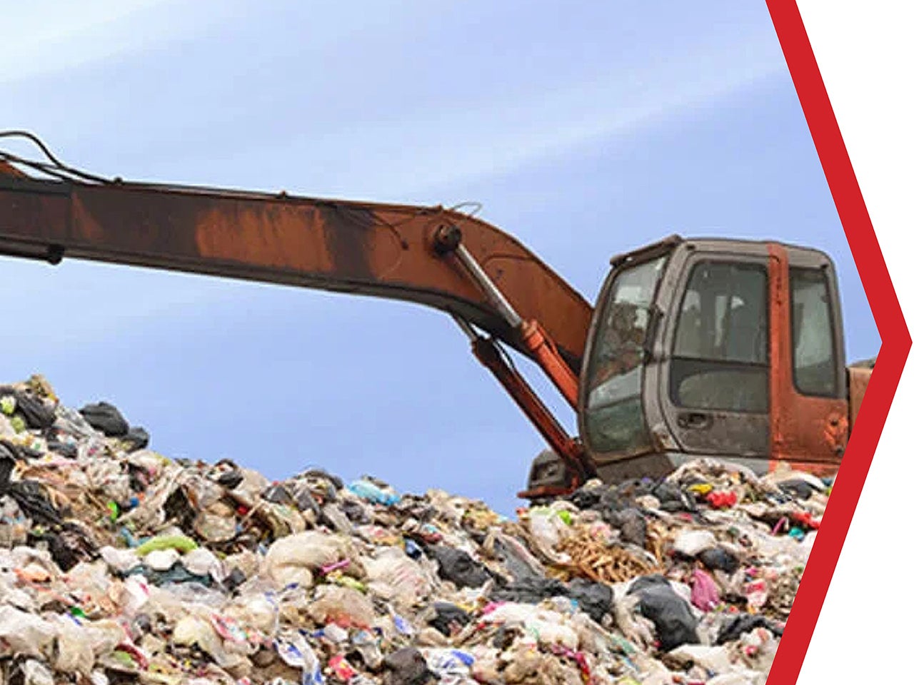 Tractor pushes trash around landfill