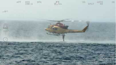 Helicopter with rescue crew over the sea