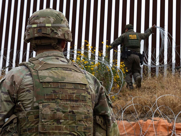 Police officers near border fence