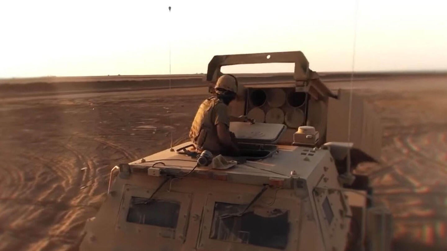 Soldiers inspect a missile launcher
