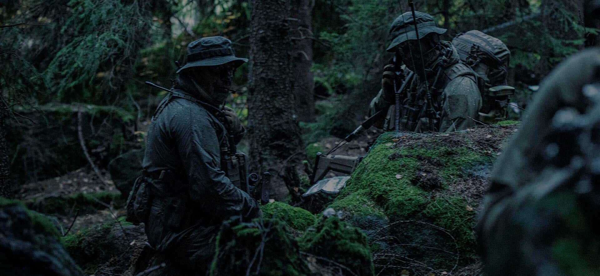 soldiers in camouflage in wooded area