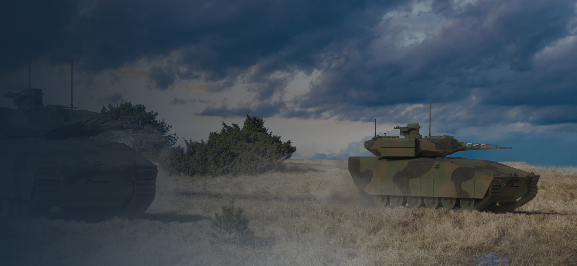 A few tanks in a field underneath a rolling sky