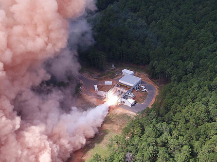 A solid rocket motor test fires at a facility