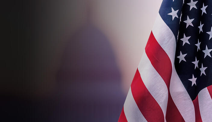 American flag with building in background